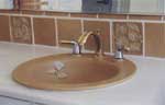 This handmade sink with a matching tile backsplash brings a much appreciated <br> touch of beauty to a bathroom.